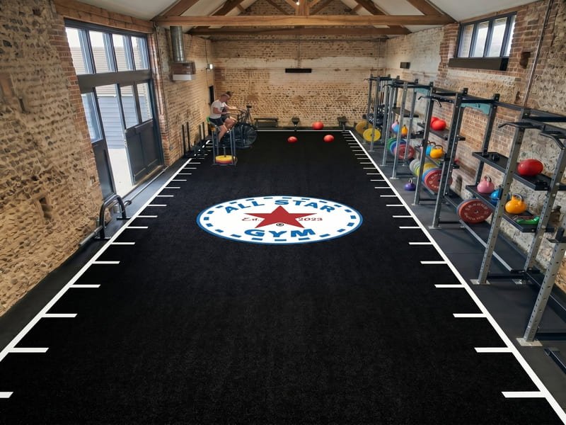 damaged gym turf with visible fiber crushing and matting